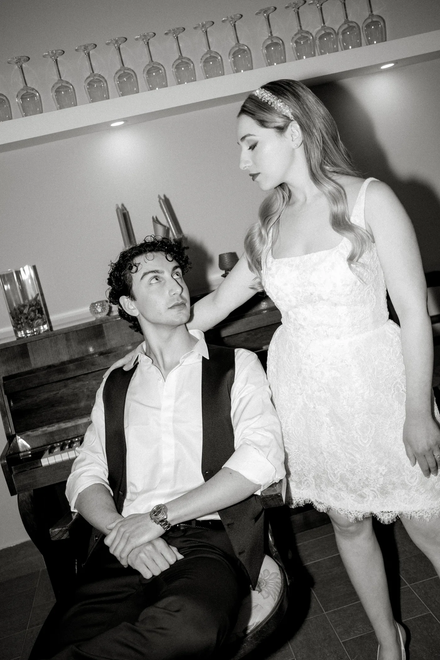 Couple together by the piano, black and white